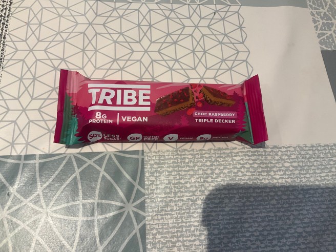 A Tribe Triple Decker Bar lies on a tablecloth with various duck egg colour scheme patterns.